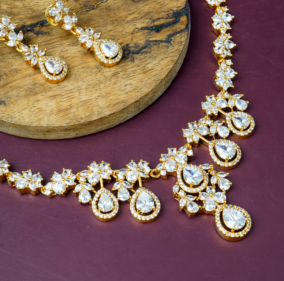 Gold crystal floral necklace set with ruby teardrop stones and matching earrings